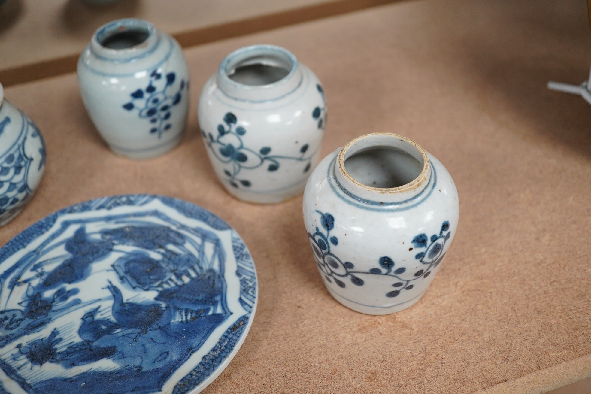 Three Chinese blue and white jars and a dish centre, late Ming dynasty, largest 13cm in diameter. Condition - fair